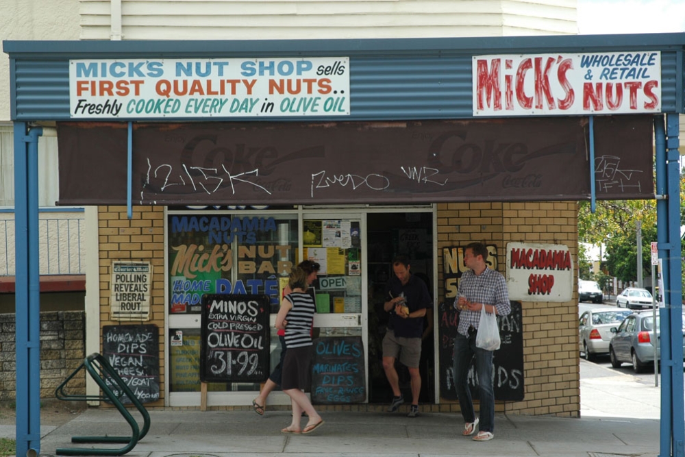 Customers at Mick’s Nut Shop entrance on Hardgrave Road, hand-painted signage above.